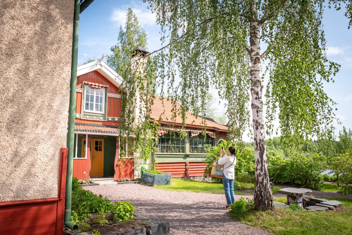 Person fotograferar entrén till Carl Larsson-gården i Sundborn.